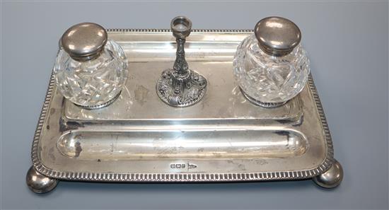 A late Victorian silver rectangular inkstand with taperstick and two later associated silver mounted wells, stand 20 oz.